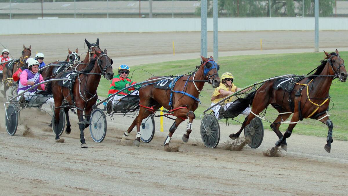 Ian Verning and Alyeska Dream (outside) move up to tackle Itaintrocketscience and Sally Torrens (front right) and Darren Elder and Rawhide Shannon on the way to winning yesterday’s Easters Landscape Supplies Pace Final at Tamworth Paceway. Photo:  Robert Chappel 281212RCI03