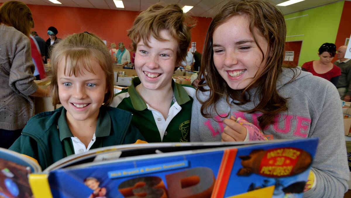 SPOTTING BOOK BARGAINS: Eight-year-old Rebekah and 12-year-old Lyndell Boschma  with 11-year-old Jessica Currey-Steman checking out the books on offer.  Photos: Barry Smith 040513BSA07