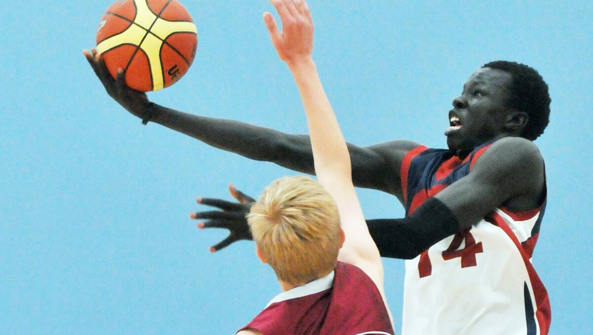 Makuach Maluach soars for one of his impressive lay-ups in a 40 point effort to spearhead his Armidale High Under 15 side to a regional final win over Quirindi High in Tamworth yesterday. Photo: Geoff O’Neill 100913GOB05