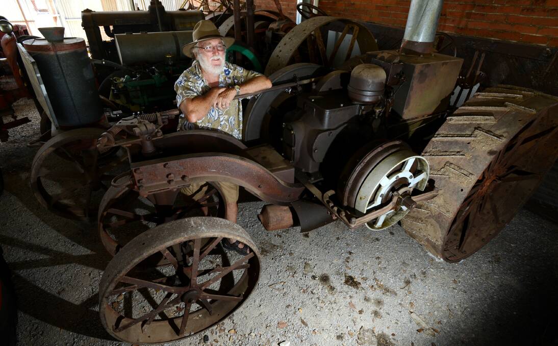 CELEBRATING A CENTURY: Manilla Museum president Ian Bignall with the 100-year-old Mogul tractor. Photo: Barry Smith 070114BSD02