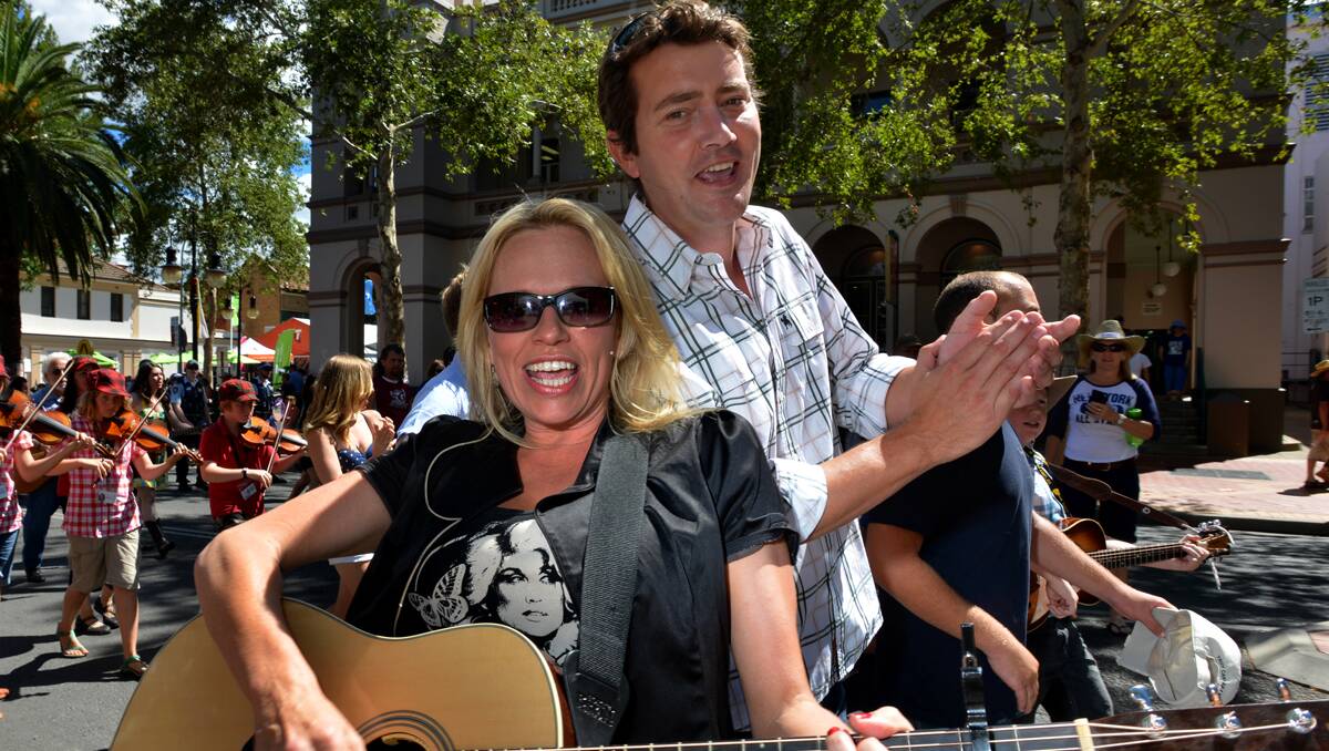 COME BACK NEXT YEAR: Beccy Cole and Adam Harvey led the flashmob-style launch of the 2014 Tamworth Country Music Festival. Photo: Paul Mathews 250113PMC04
