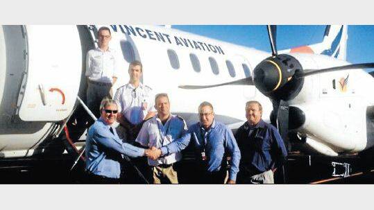WELCOME: Narrabri mayor Conrad Bolton, left, shakes hands with Vincent Aviation's CEO Murray Collings, centre, as Narrabri councillor Ron Lowder, right, and the plane’s crew watch on.
