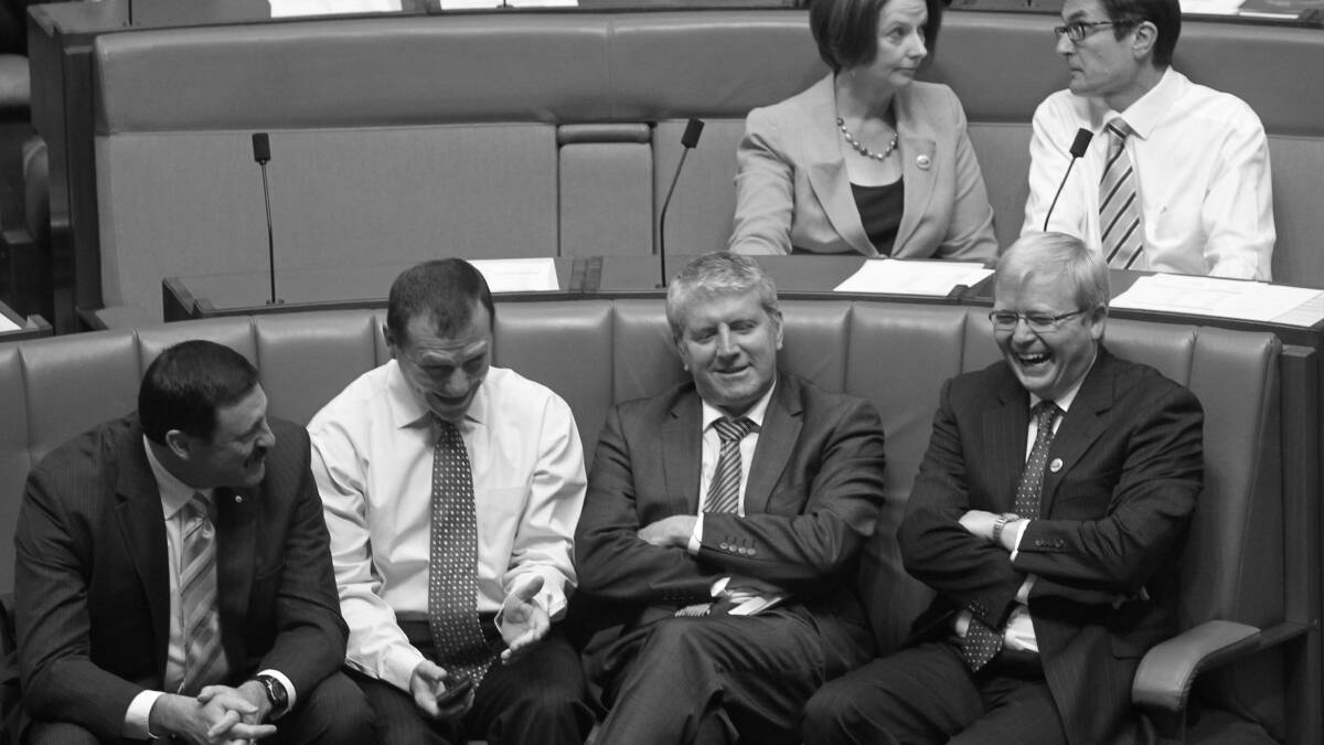 Foreign minister Kevin Rudd talks with L to R Defence parliamentary secretary Mike Kelly backbencher Graham Perrett and Human Services minister Brendan O'Connor as Prime Minister Julia Gillard and Climate Change minister Greg Combet vote to defeat Tony Abbott's amendments to the Medicare Levy Surcharge Bill at Parliament House Canberra on Wednesday 15 February 2012. The Bill later passed. Photo: Andrew Meares