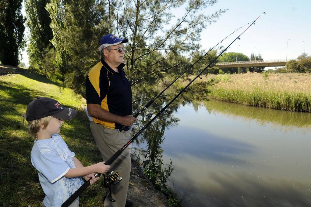Jim Beattie with his grandson Aiden Webb, 4, on the bank on the Macquarie River getting ready for the Carp Blitz. Picture: Phill Murray