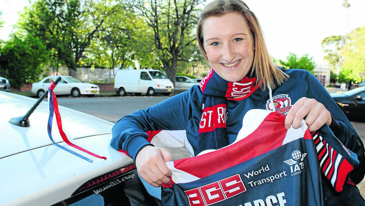  Bianca Hughes shows her true colours, flying the Roosters colours on her car and proudly showing the jersey signed by her favourite player.