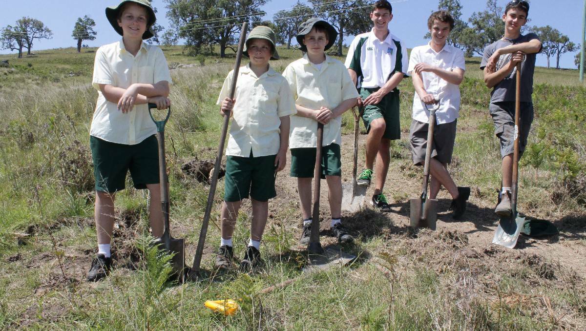Sapphire Coast Anglican College students make the final preparations on their custom-built mountain bike track before its official opening.