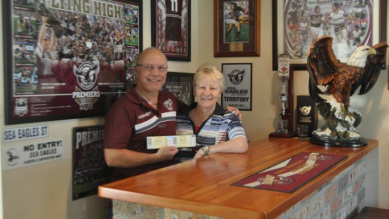  Ian and Diane Pedley with their grand final tickets behind the bar of their very Manly-orientated home. 