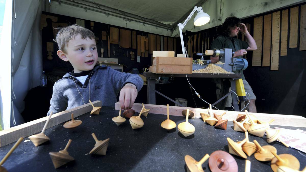 Rueben Duncan, 6, of Derwent Bridge, plays with some spinning tops. Picture: Will Swan