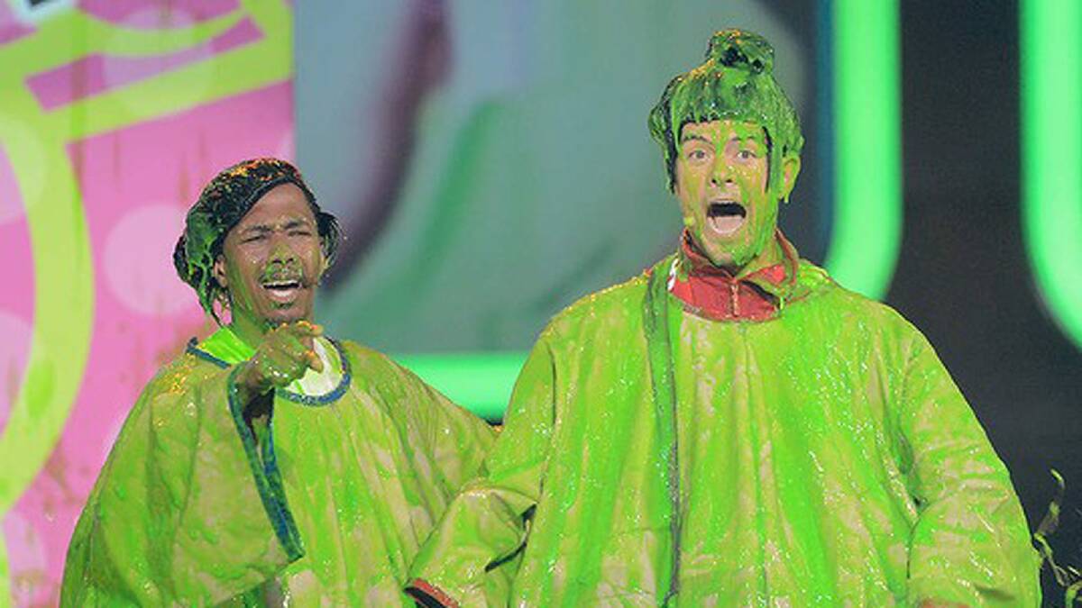 Nick Cannon, left, and host Josh Duhamel get slimed. Photo: Getty Images