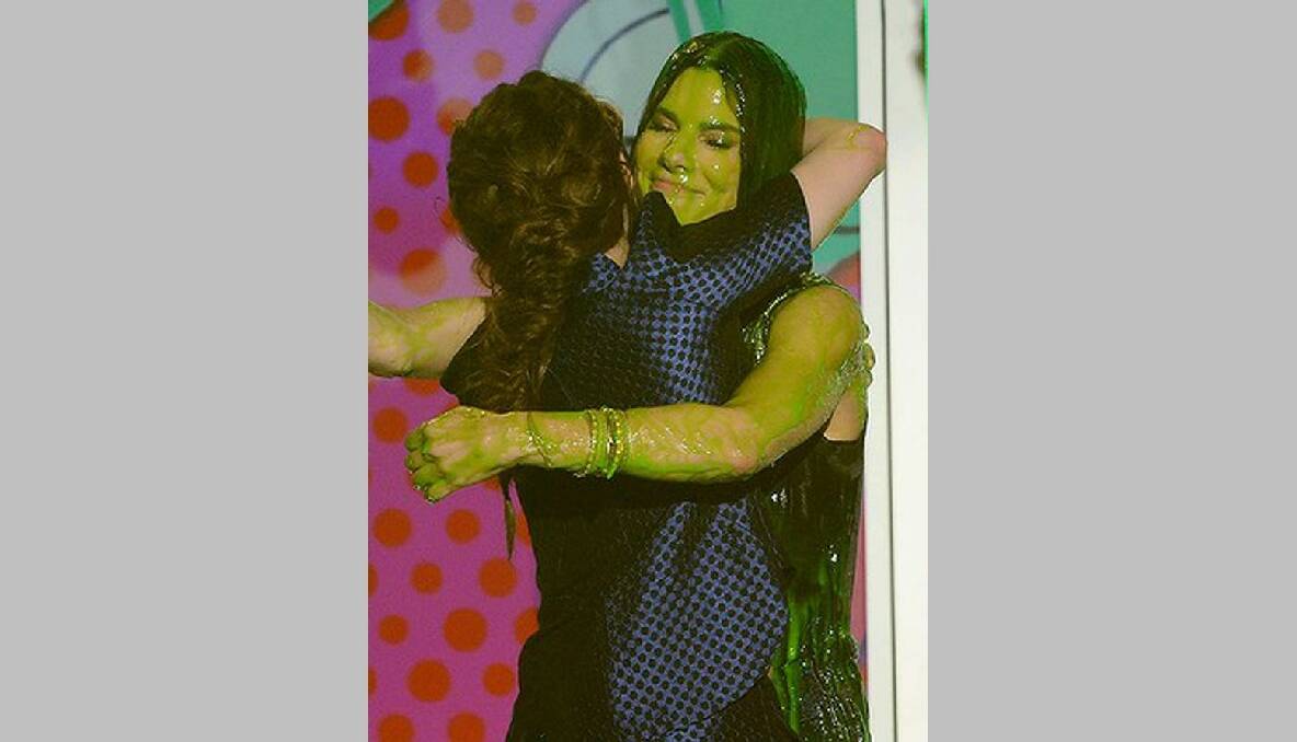 Kristen Stewart hugs Sandra Bullock after getting slimed during Nickelodeon's 26th Annual Kids' Choice Awards. Photo: Getty Images