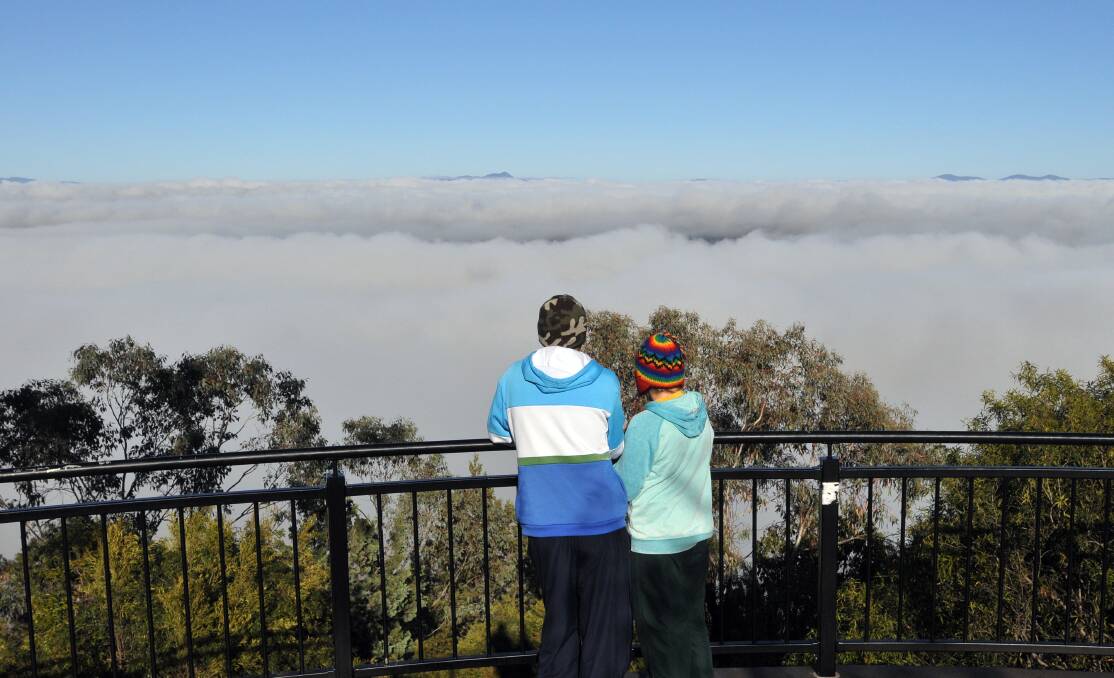 Residents check out the early morning fog from the Tamworth Lookout in August. Photo:Geoff O'Neill 180812GOA04
