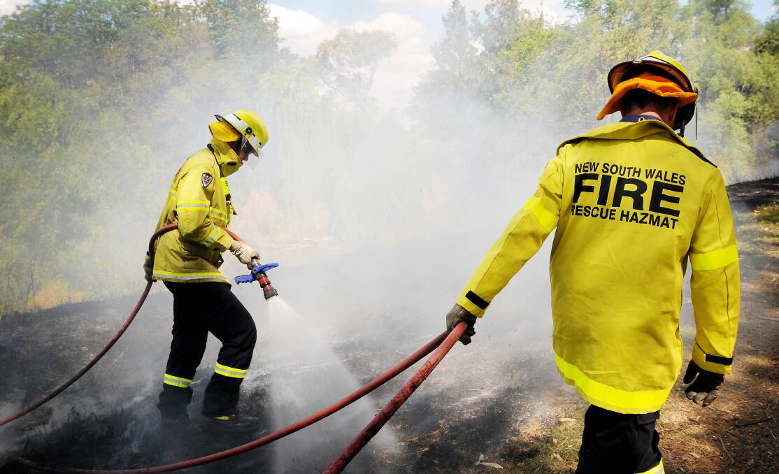 Firefighters work to extinguish a blaze by the Peel River in Tamworth. Photo:Gareth Gardner. 301013GGB01