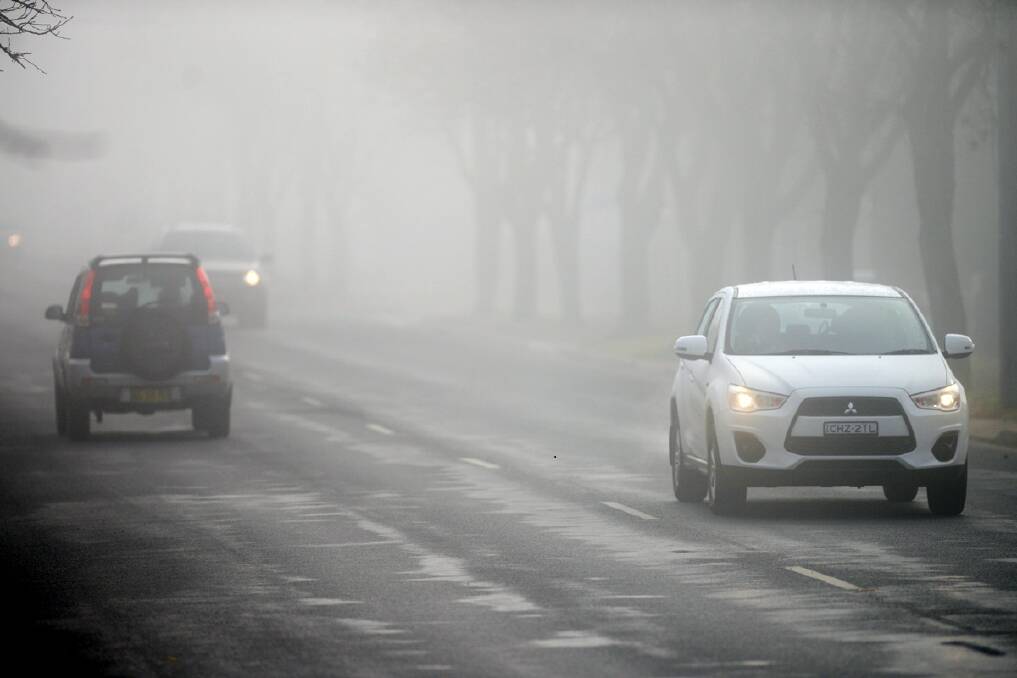 Traffic early morning in Marsh Street negotiating an unsually thick "pea-souper" fog. Photo:The Armidale Express.