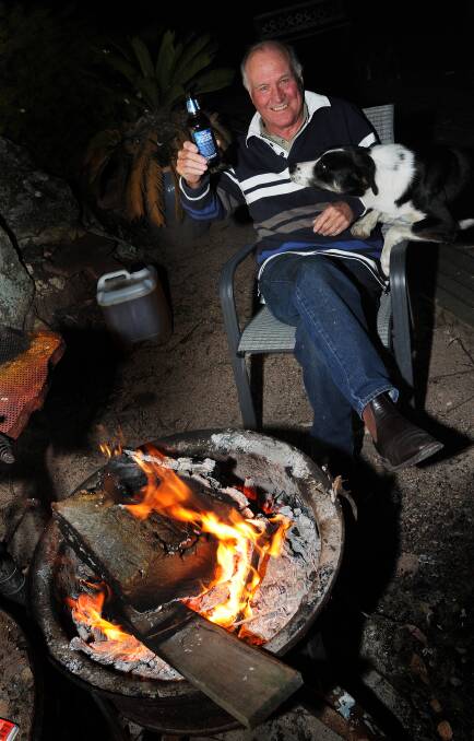 Tony Windsor relaxes by a fire in August. Photo:Gareth Gardner 050813GGD04