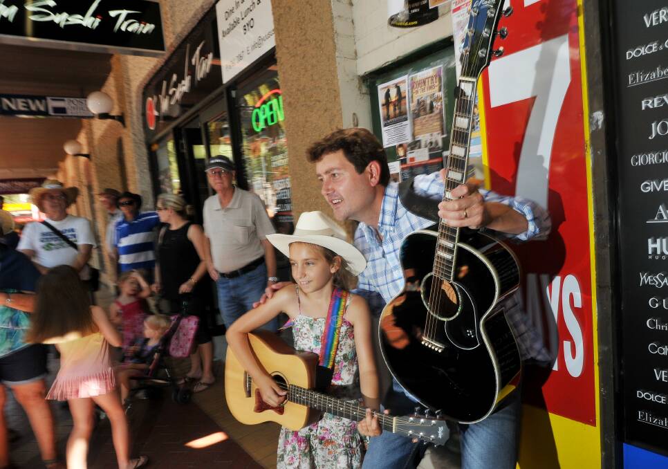 Country Music star Adam Harvey with a young fan in Tamworth's Peel St. Photo:Gareth Gardner 160114GGG03