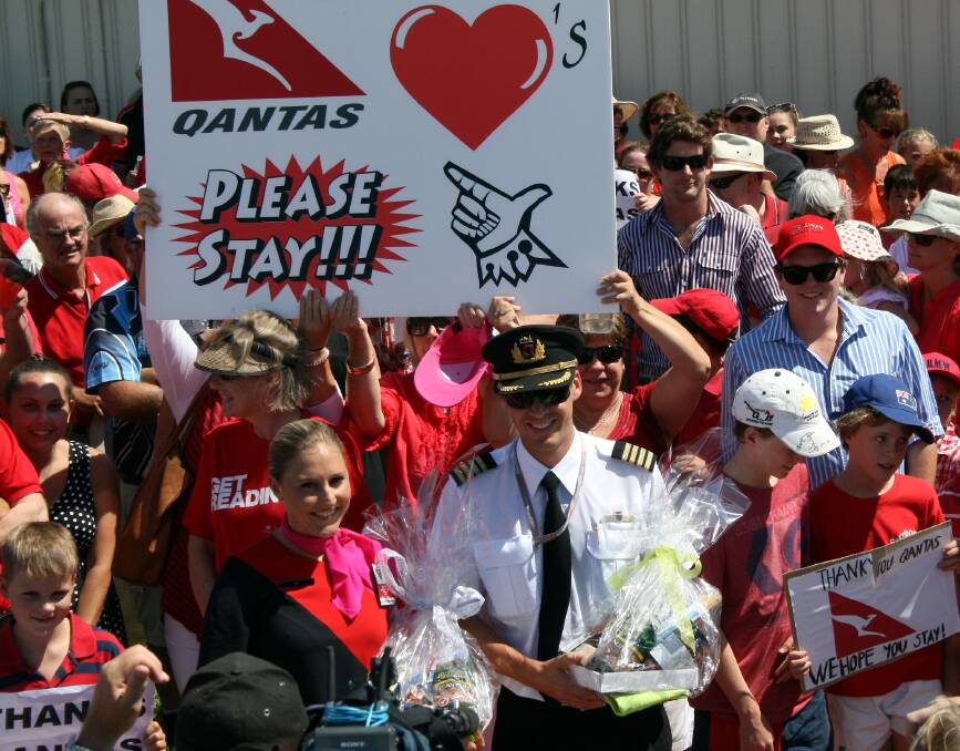 SHOW OF THANKS: QantasLink flight attendant Jen Rendy and captain Rob Langfield receive gifts from during a public rally at Moree Airport today. 