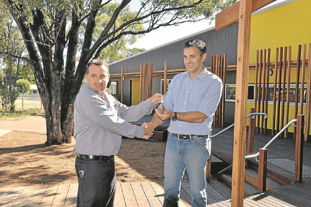 The keys to Winanga-Li Aboriginal Child and Family Centre were handed over last week in Gunnedah, with the official opening to be held in July. Pictured are Simon Munro and Lance Bright. - The Namoi Valley Independent 