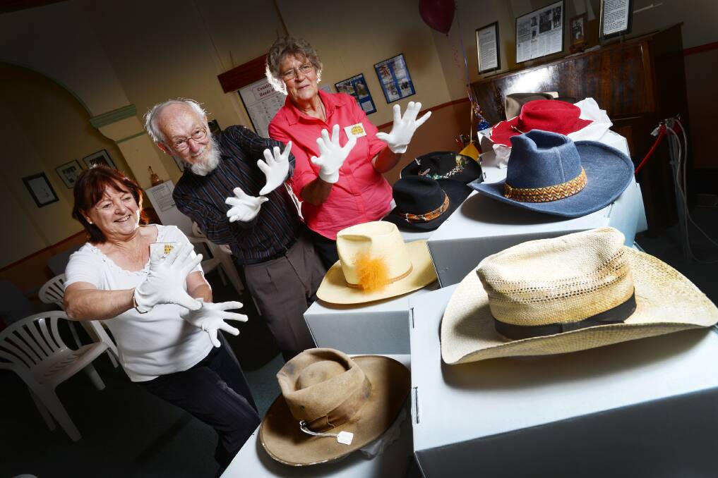 Australian Country Music foundation volunteers Hillary Scott, Barrie Brenna and Judy Loffel with some historic hats. Photo:Barry Smith 220114BSE04
