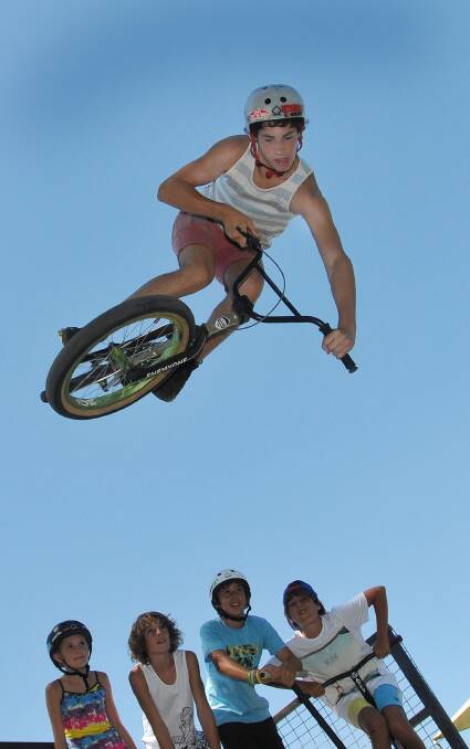 Jake Taylor gets some air on his bike while his mates watch on at the Tamworth Skate Park in January. Photo:Geoff O'Neill 020113GOA01