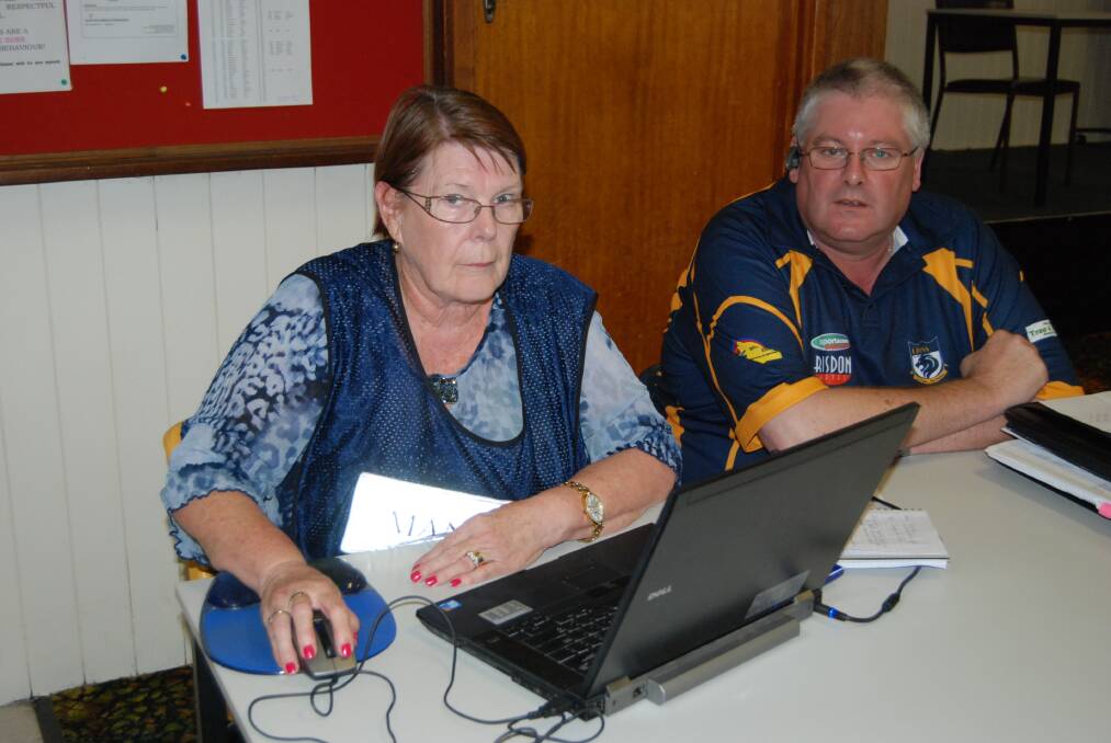 Port Pirie relief centre operations manager Robyn Aylesbury and Lions Club president Bryan Jensen draw up  24-hour rosters ready for people fleeing from fires at Port Germeine.