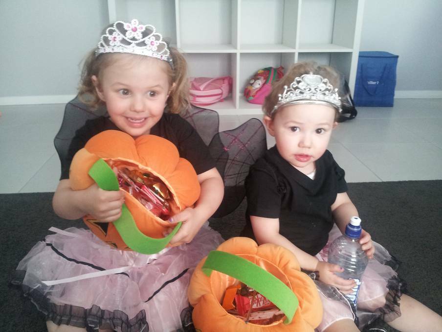 Spooky fairies Madison, 4, and Eloise, 2, Gwynne with their stash of goodies after their very first trick or treat expedition. Photo: KELLIE LALOR