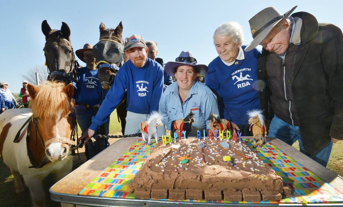 BIRTHDAY BITS: Buttons the little horse was all for a front row seat at the birthday cake at Riding for the Disabled in Tamworth, with patron Craig Beacroft, Kelly Usher, and patrons Marie Lucas and John Stokoe. Photo: Barry Smith 300715BSB04
