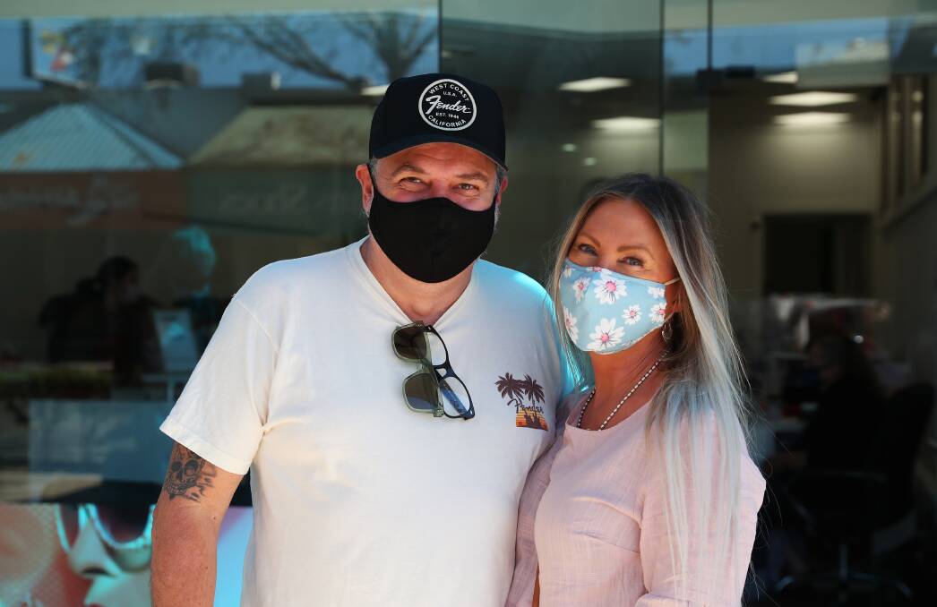 MASKED UP: Glenn and Karen Pallister were masked-up on Saturday morning while lining up for a store on Baylis Street in Wagga. Picture: Emma Hillier
