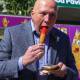Leader of the Opposition Peter Dutton enjoys a dagwood dog at the Ekka show on Wednesday, August 10, 2022. Photos: AAP.