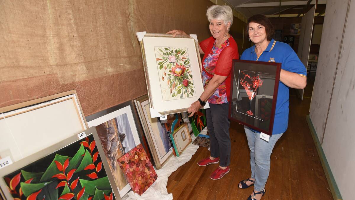 ON SHOW: Lee Rodger and Julie Attard with some of the artworks that will be up for sale on the weekend. Photo: Peter Hardin