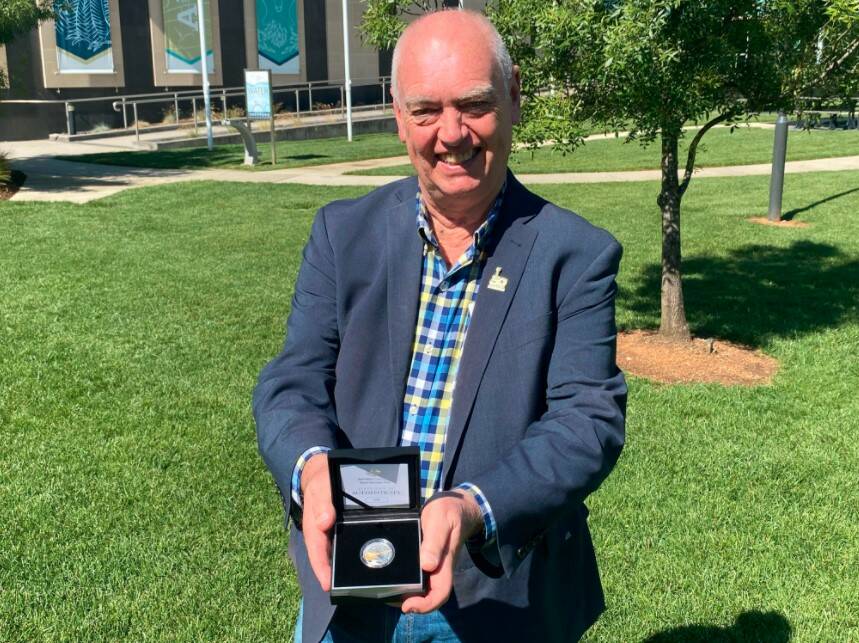 SILVER AND GOLD: Tamworth Country Music Festival Manager Barry Harley shows off the limited edition 50 cent coin. Photo: Supplied
