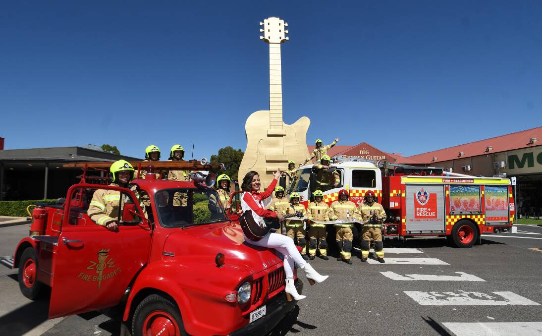 NSW Fire and Rescue crews from Tamworth with country musician Amber Lawrence to recreate the photo from 1994. Picture by Gareth Gardner