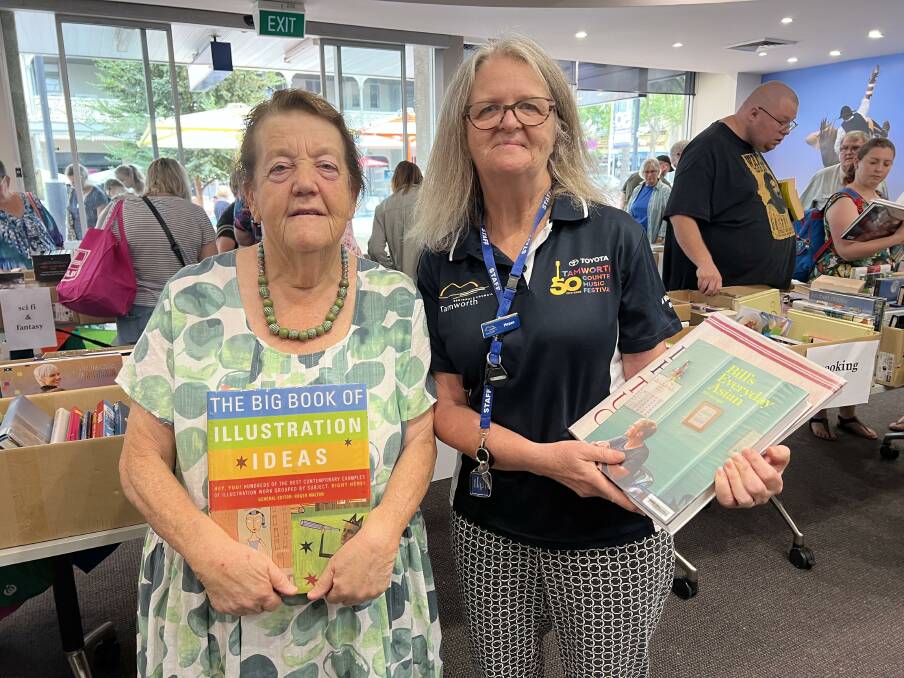 READING: Kay Driver and Tamworth Regional Council staff member Megan Pitt show off what's on offer. Photo: Tess Kelly
