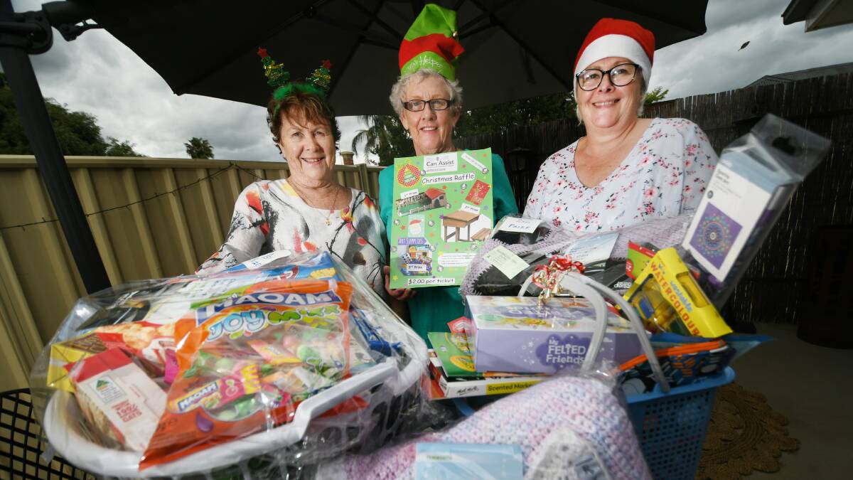 PRIZES: Robyn Fitzgerald, Marjorie Keech and Jill Grey with the goods up for grabs in the Can Assist raffle. Photo: Gareth Gardner