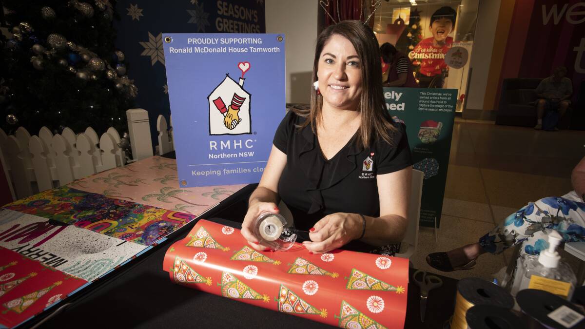 FESTIVE FUNDS: Tamworth's Ronald McDonald House Manager Rhiannon Curtis wrapping presents at Tamworth Square. Photo: Peter Hardin