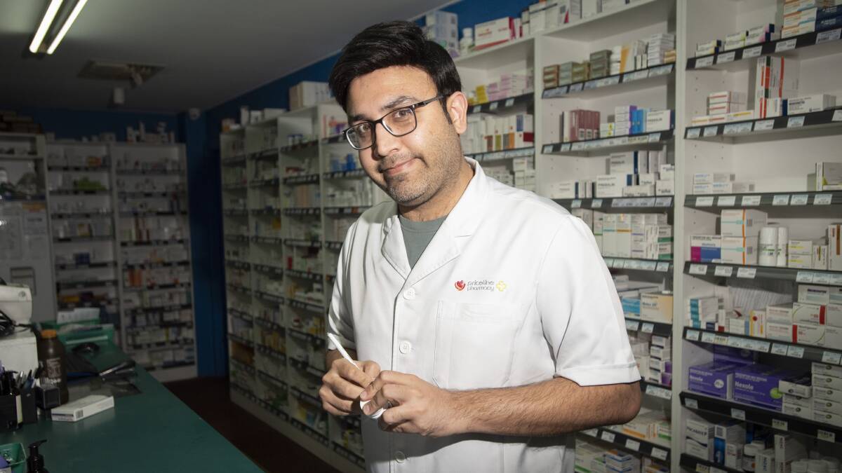 POINTY END: Priceline pharmacist Muhammad Omar Awan urges people to get the free flu jab while they can. Photo: Peter Hardin
