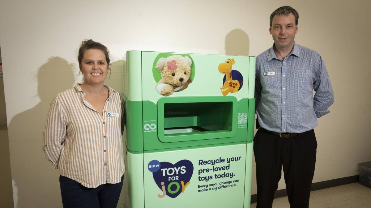 TOY STORY: BIG W Newcastle area manager Jess Lowe and Shoppingworld store manager Matt Dustin hope the new purpose-built disposal unit in front of the Tamworth store will give old, pre-loved toys another life. Photo: Peter Hardin