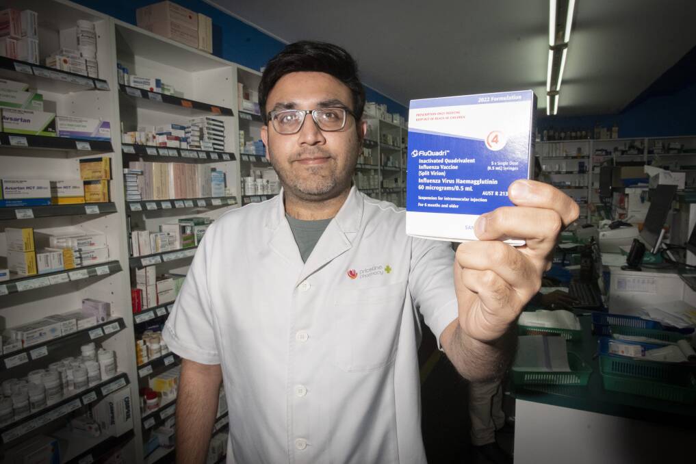 ROLL UP: Priceline pharmacist Muhammad Omar Awan urged families to get protected against influenza. Photo: Peter Hardin