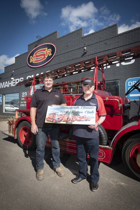GRATEFUL: Andrew Maher of Mahers Smash Repairs accepted a gift from Tamworth Classic Fire Engine Club president Barry Owen. Photo: Peter Hardin