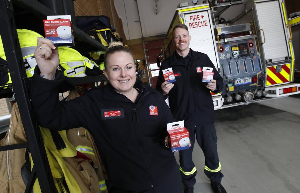 SAFETY FIRST: Turvey Park firefighters Amy Ellice and Zale Bailey with the smoke alarms that could save lives this winter. Picture: Les Smith