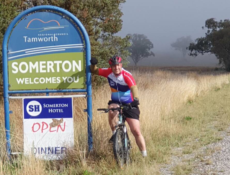 Highway Rider: Mr Harris with the Somerton sign while out on one of his many rides. Photo: supplied.