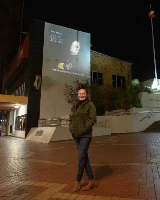 Live Art: Lisa Shipley stands in front of a projection of here photo. Photo: Mark Kriedemann