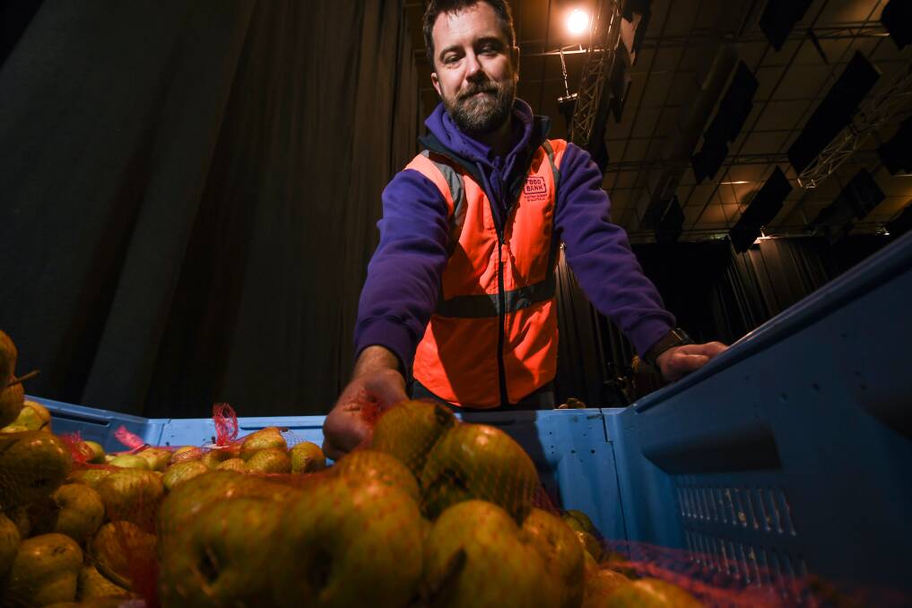 Adam Loftus helps sort fruit at Tamworth Homeless Connect. Picture by Gareth Gardener