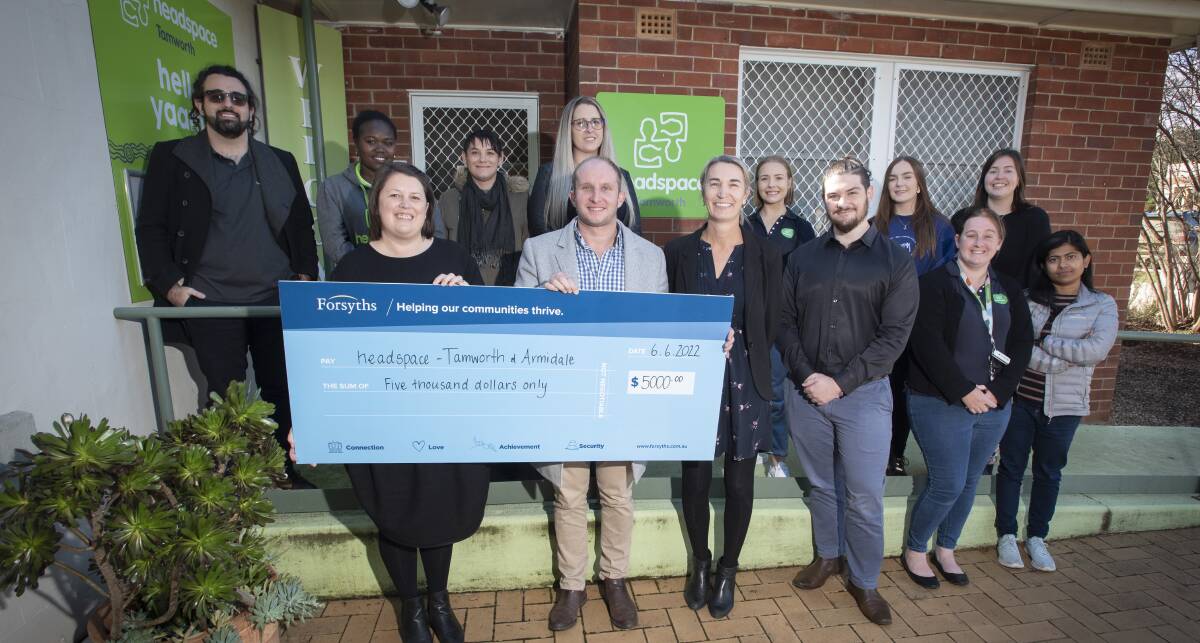 Tackling PTSD: Megan Ellbourn from Forsyths Foundation hands over the cheque to headspace manager, Sam Davis, together with the headspace team. Photo: Peter Hardin