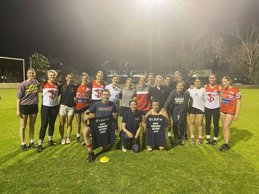 The Tamworth Swan got together at training to she around some Lifeline shirts. Picture supplied