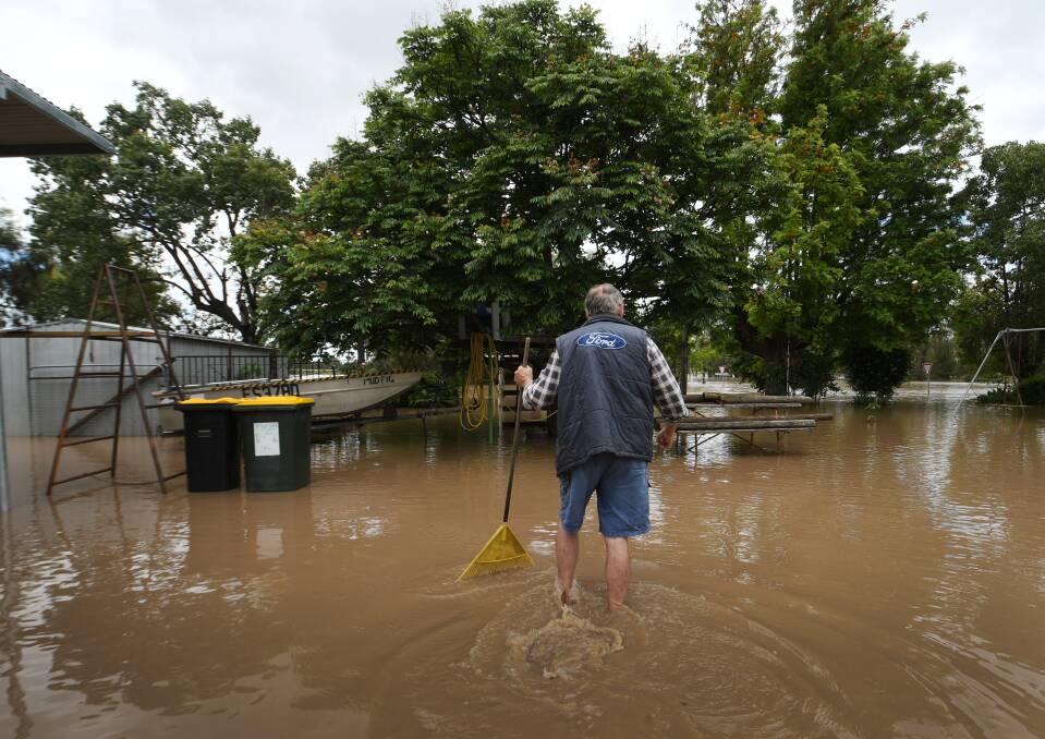 Ralph Scott gets an early start on clearing his yard of debris in North Gunnedah. Picture by Gareth Gardner