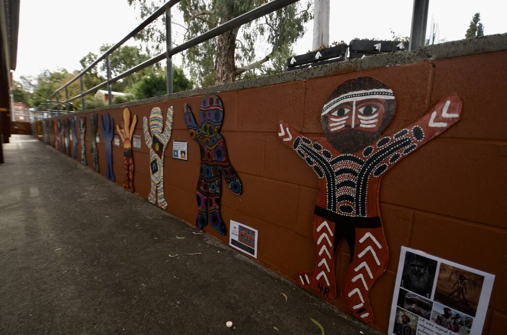Marvellous Mural: Wooden figures were painted by students. Photo: Gareth Gardener.