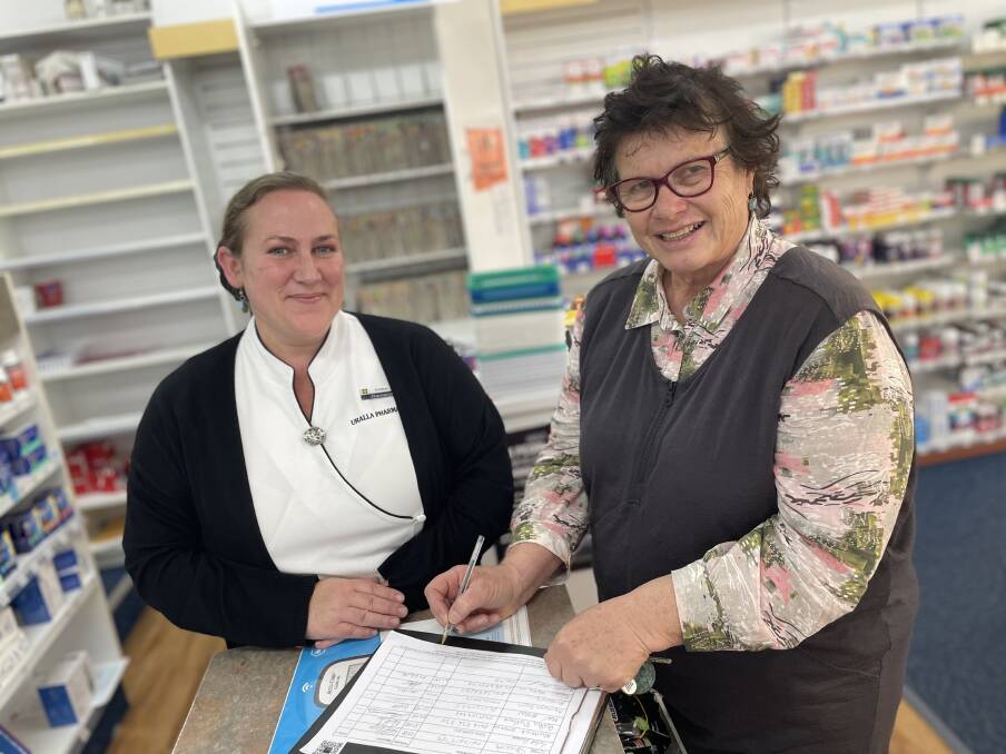 Uralla pharmacist Amber Poflotski with local customer Jann Karp who signed the petition to try and stop the 60-day prescription changes being introduced. Picture by Laurie Bullock