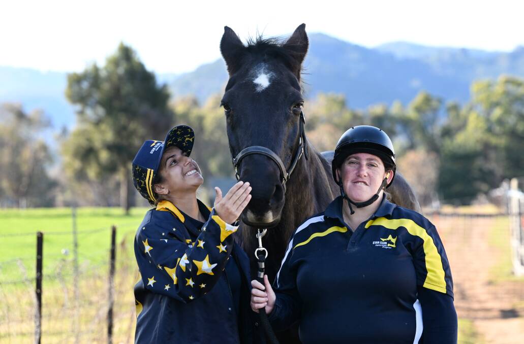Eliza Simpson and her best friend Kelly Usher, with Battler the horse at Melissa's Equestrian Academy. Picture by Gareth Gardner