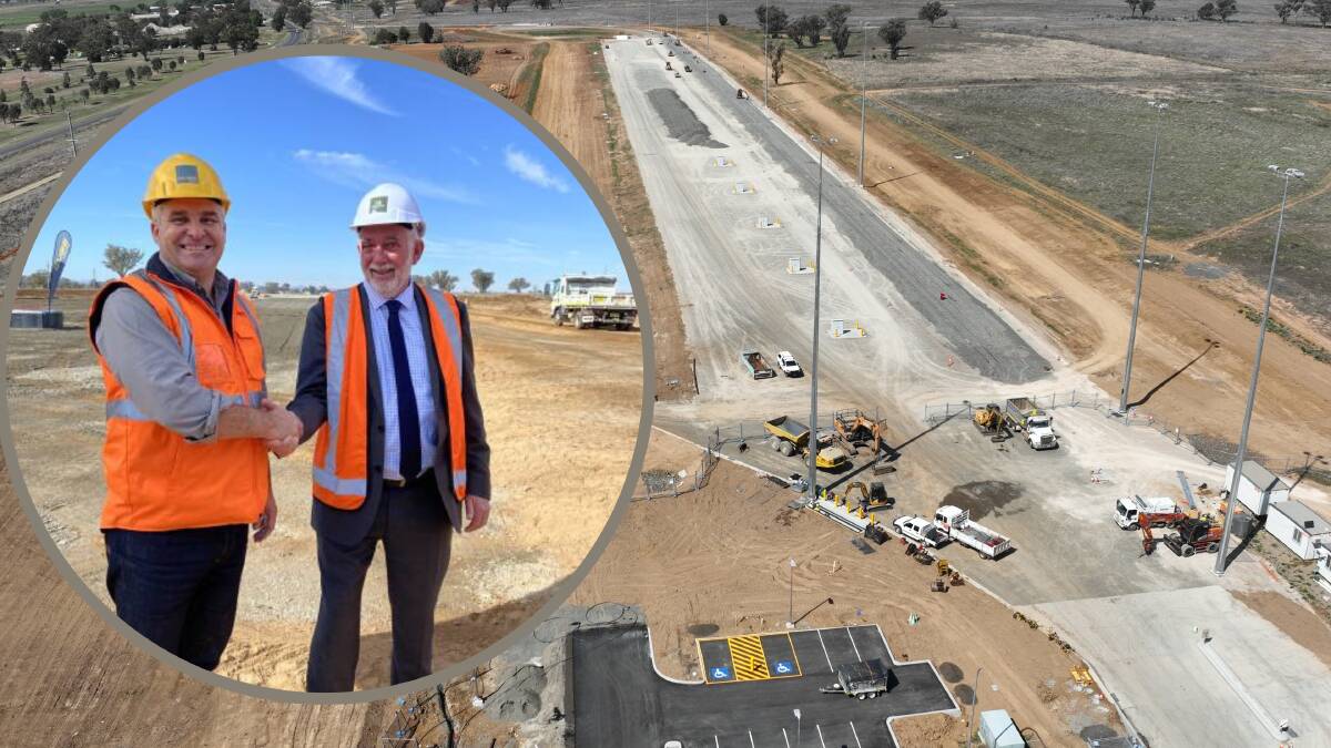 Qube's general manager Sean Hovey, left, shakes the hand of Tamworth mayor Russell Webb in May this year during the height of construction on the freight train hub in Westdale. Pictures supplied