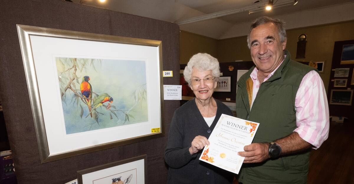 Tamworth-based artist Yvonne Overton receiving the award for best Watercolour and Pastel for her painting "Rainbow Lorikeets" by Bendemeer Art Show Committee president Jamie Hook. Picture by Peter Hardin